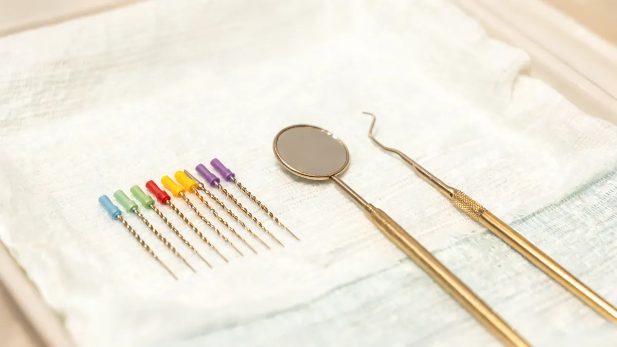 Thin nickel-titanium root canal files, a dental mirror and an explorer arranged on a sterile tray